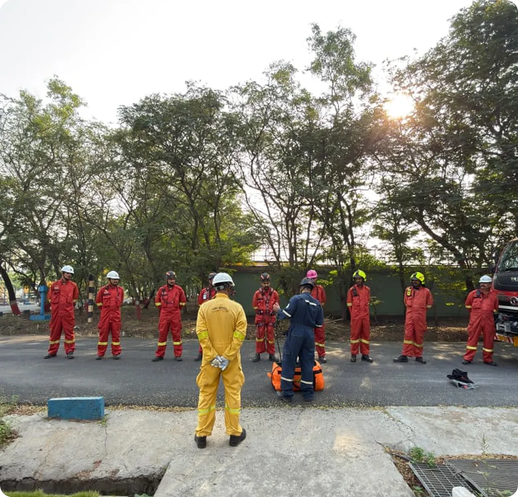 Road Safety Marshalls - Five safety personnel in orange high-visibility uniforms managing traffic safety